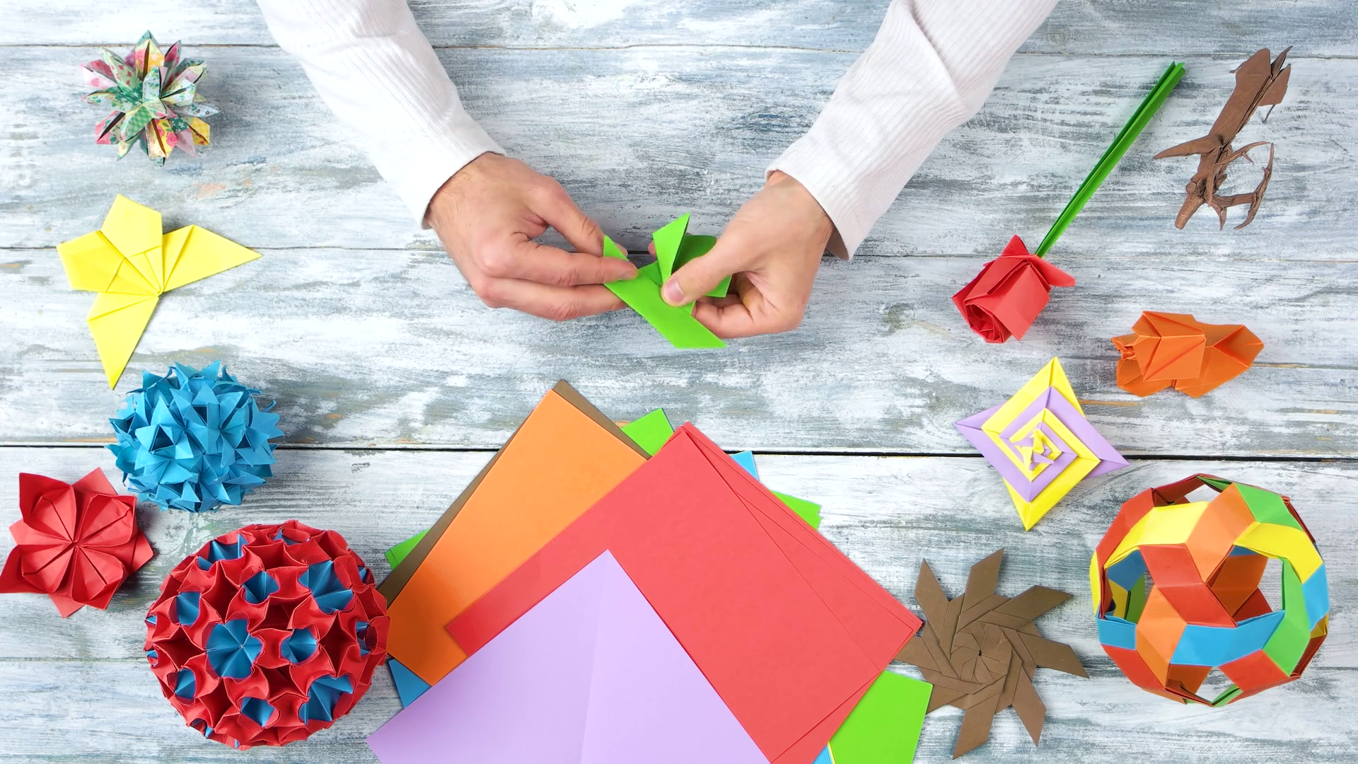 videoblocks-man-folding-paper-frog-top-view-paper-folding-workshop-hand-crafting-project-idea-for-kids_sibnpk7pg_thumbnail-1080_01